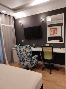 a bedroom with a desk and two chairs and a computer at Guest Room Star Avenue in Shah Alam