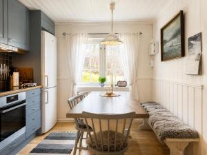 a kitchen with a wooden table and a window at Hallingstue by Hallstensgaard - Geilo in Geilo +17 photos
