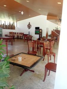 a room filled with wooden tables and chairs at Sigiri Nisala Resort in Sigiriya