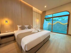 a bedroom with a large bed with a large window at The Apex private pool villa Krabi in Krabi