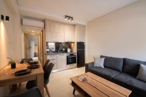 a living room with a couch and a table at Virea VA Complex in Vaia