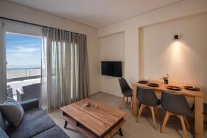 a living room with a table and a couch at Virea VA Complex in Vaia