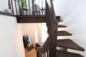 a staircase leading up to a room with a chair at Apartment Schweriner Lieblingsplatz in Schwerin