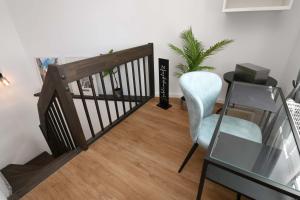 a wooden staircase with a chair and a glass table at Apartment Schweriner Lieblingsplatz in Schwerin