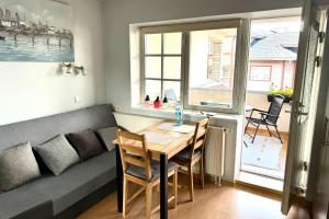 a living room with a couch and a table at Maria Apartment Tolli põik in Kuressaare