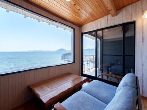 a room with a couch and a view of the ocean at Costa Del Sol HIJI in Hiji +121 photos