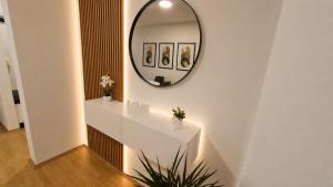 a mirror on a wall above a white counter at Urban Center Paraćin in Paraćin