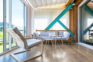 a living room with a couch and a table at Chalet avec jardin et vue 6 personnes in Espezel