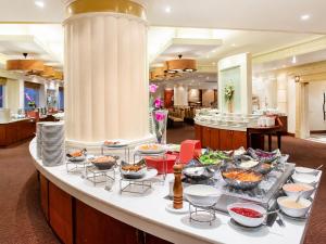 a buffet in a hotel with many bowls of food at The Palazzo Hotel in Bangkok