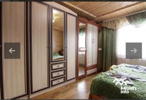 a bedroom with a bed and a large mirror at Микуличин на долоні 2 in Mykulychyn