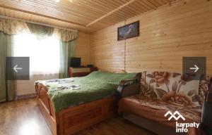 a bedroom with a bed in a log cabin at Микуличин на долоні 2 in Mykulychyn