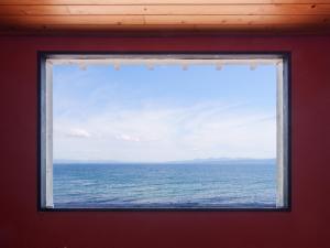 a window in a room with a view of the ocean at Costa Del Sol HIJI in Hiji