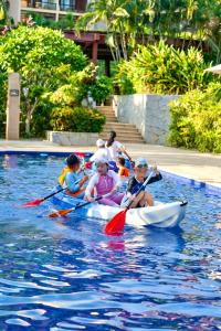a group of children in a kayak in the water at Yalong Bay Mangrove Tree Resort in Sanya