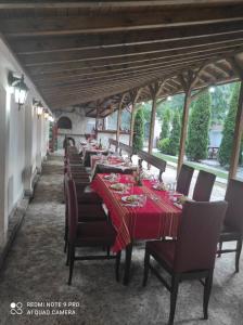 a long row of tables with red table cloth at Tzvetelina Palace Hotel in Dolna Banya