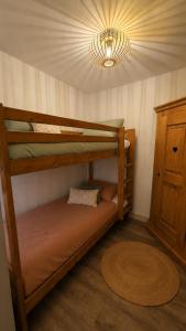 a bedroom with two bunk beds and a chandelier at Appartement in Vielle-Aure +7 photos