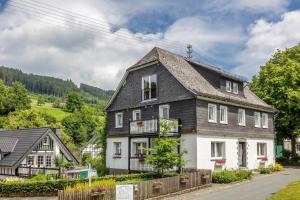a large house with a gray roof at Ferienhof Pohl-Optimal für Familien in Lennestadt