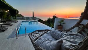 a swimming pool with a hammock next to at Infinity villa in Fethiye