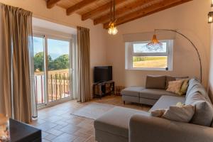 a living room with a couch and a tv at um pouco de campo in Torres Vedras