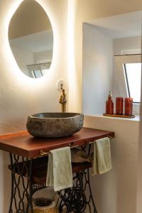 a bathroom with a stone sink and a mirror at um pouco de campo in Torres Vedras +31 photos