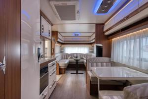 an interior view of an rv with a table and chairs at Kemping Molo Surf by Q4Camp in Jastarnia
