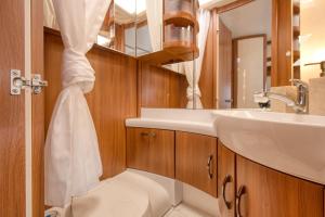 a bathroom with a sink and a toilet at Kemping Molo Surf by Q4Camp in Jastarnia +20 photos