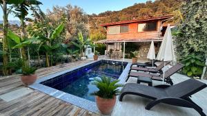 a house with a swimming pool next to a house at Infinity villa in Fethiye