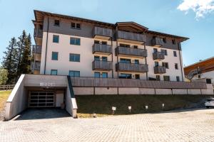 a large building with a parking lot in front of it at Haus Tauernblick am Katschberg in Katschberghöhe