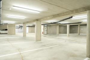 an empty parking lot with concrete pillars in a parking garage at Haus Tauernblick am Katschberg in Katschberghöhe