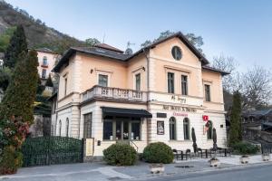a large building with tables in front of it at Mr Görgey Art Hotel in Visegrád