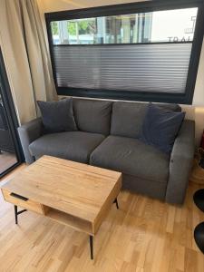 a living room with a couch and a coffee table at Hausboot mit Sauna - TraumZeitBoot Heidi - exklusiver Festlieger in perfekter Lage am Scharmützelsee Bad Saarow in Bad Saarow