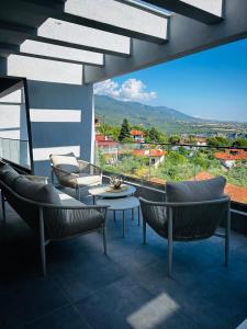 a living room with chairs and a table and a view at Olympus Pearl in Skotina