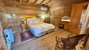 a bedroom with a bed in a wooden cabin at Infinity villa in Fethiye