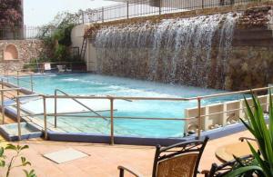 a swimming pool with a waterfall at Achilleion-Edipsos in Loutra Edipsou