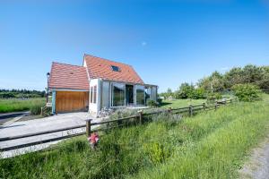 a house in a field with a fence at Chalet avec jardin et vue 6 personnes in Espezel