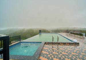 a large swimming pool on top of a building at Nature Green Pool Resort Munnar by VOYE HOMES in Munnar