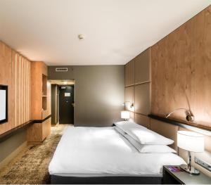 a hotel room with two beds and a tv at Radisson Blu Szczecin in Szczecin