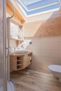 a bathroom with a skylight and a sink at Appartements Alpenrose in Längenfeld +52 photos