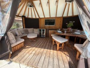 a living room with a couch and a table at Granary Cottage in Chippenham