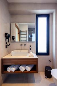 a bathroom with a sink and a mirror at TAYS Hotel in Kalamata +92 photos