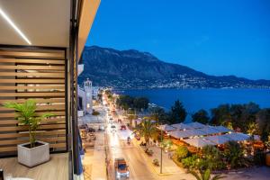a view of a city at night from a building at TAYS Hotel in Kalamata