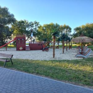 a park with a playground with a slide at Jeziorskie Zacisze & balia in Łyszkowice