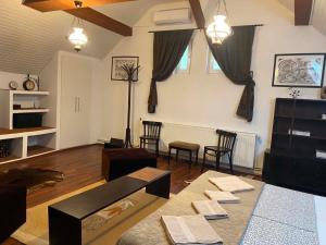a living room with a couch and a table at Lilu House in Câmpina