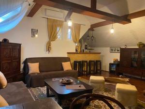 a living room with a couch and a table at Lilu House in Câmpina