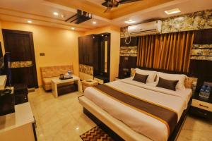 a bedroom with a large bed in a room at Mohar Residency - VIP Road in kolkata