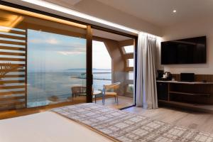 a bedroom with a view of the ocean at TAYS Hotel in Kalamata