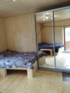 a room with two beds and a mirror at Вершина спокою in Mykulychyn