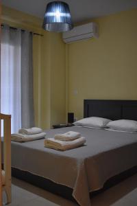 a bedroom with two beds with towels on them at VILLA IN THE OLIVE TREES Galaxidi in Galaxidi +84 photos