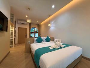 a bedroom with a large bed with a towel on it at The Apex private pool villa Krabi in Krabi +74 photos
