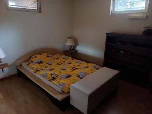 a small bedroom with a bed and a dresser at Huis bij basel in Hésingue