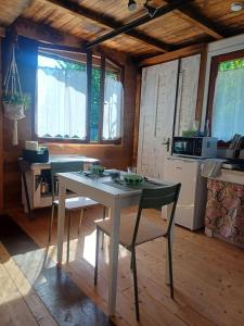 a kitchen with a table and chairs in a room at Jasmine & Rose House in Udine